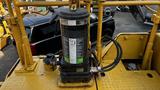 Caterpillar 326F L Excavator featuring a cylindrical filter with labels and hoses connected to the machine