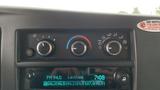 Dashboard controls of a 2017 Chevrolet Express Quigley 4x4 including climate and audio settings display