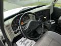 Interior view of a 2013 International DuraStar featuring a black steering wheel and dashboard with multiple gauges and controls