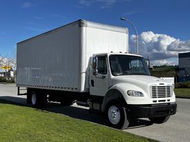 A white 2016 Freightliner M2 106 box truck parked on a curb with a cargo area that has a smooth exterior and a visible grille on the front