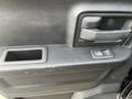 Close-up view of the interior door panel of a 2015 RAM 1500 showing the door handle and window control button
