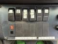 A control panel with various switches labeled for heat and air conditioning features in a 2010 Ford Econoline
