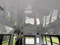 Interior view of a 2013 Chevrolet Express showing the ceiling with emergency exit signage and overhead lighting details