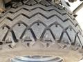 Close-up of a rugged tire tread from a 2018 Kubota RTV-X 1100 C showcasing a zigzag pattern and deep grooves designed for off-road traction