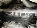 Close-up of a Detroit Diesel engine with visible lettering and piping, featuring the brand name prominently displayed on the engine block