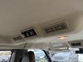 The interior ceiling of a 2021 Chevrolet Express showing climate control vents and a light switch