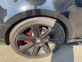 A close-up of a black wheel on a 2015 Bentley Continental GT featuring a five-spoke design and red brake calipers