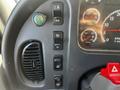 Dashboard controls of a 2004 Freightliner M2 including various buttons for lights and vehicle settings