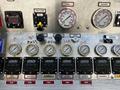 Control panel of a 2006 Emergency One Fire Truck with various gauges and switches labeled for foam and water discharge systems