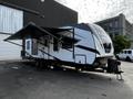 A 2022 Heartland Torque travel trailer featuring a glossy exterior with angular lines and a large front window attached to a black hitch