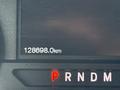 The dashboard display of a 2019 Ford F-150 showing the odometer reading of 128698.0 km along with the gear shift indicators P R N D M