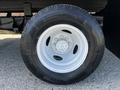 A 2019 Ford Econoline tire featuring a silver rim and black tread pattern with the size label LT225 75R16 on the sidewall