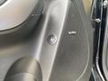 Close-up of a door panel in a 2015 Kia Sorento featuring an Infinity audio speaker and a button for the fuel release