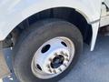 Close-up of the front wheel of a 2014 International TerraStar showing the tire and silver rim with visible lug nuts