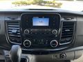 Dashboard of a 2021 Ford Transit featuring a digital display and various control buttons for audio and climate settings
