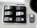 Control panel of a 2015 Spartan School Bus featuring several toggle switches and buttons for cruise control and various functions