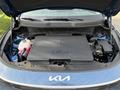 A 2023 Kia Niro EV with its hood open showcasing the electric engine compartment and components inside