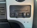 Control panel of a 2014 Ford F-150 featuring the trailer brake with two buttons and a slider for adjusting settings