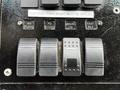 Control panel with labeled switches for fast idle park brake flood lights and other functions on a vehicle