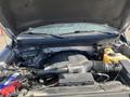 A 2014 Ford F-150 engine compartment with the hood raised showing various engine components and fluids