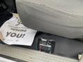 A 2003 Ford F-450 SD with a gray seat and a control panel for a VMAC system on the floor in front of the seat