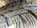 Close-up of a tire tread from a 2016 Ford Transit showing deep grooves and a rugged pattern designed for traction and durability