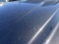 Close-up of the glossy surface of a 2016 Chevrolet Tahoe showing fine scratches and sparkling flecks within the paint