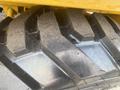 Close-up of a large tire from a 2024 AGT KRW 23 Mini loader showing distinct tread patterns and rubber texture