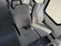 Interior seating of a 2010 Ford Econoline featuring two grey upholstered seats with armrests and seatbelt buckles
