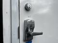 A door handle and combination keypad lock on a white climate controlled storage container