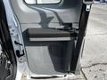 A 2011 Ford F-450 SD door panel featuring a storage compartment and a vent design with a seatbelt mounted on the side