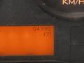 A digital display showing a mileage reading of 84990 kilometers on a vehicle dashboard