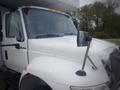 A 2017 International 4300 truck with a white exterior and a large front grille featuring chrome accents and side mirrors