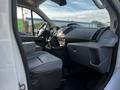 Interior view of a 2017 Ford Transit showing the driver's seat dashboard and controls with grey accents and storage compartments