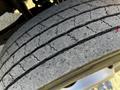 Close-up of a worn tire tread on a 2008 Ford F-450 SD showcasing visible cracks and reduced tread depth