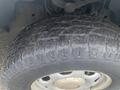 Close-up of a tire from a 2013 Ford F-150 showcasing tread patterns and a silver alloy wheel