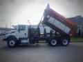A 2016 International WorkStar 7500 truck with a raised dump bed showcasing its large wheelbase and boxy design