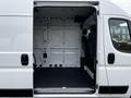 A 2021 RAM Promaster with an open side door showing a spacious interior and driver's seat visible