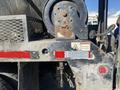 A 2014 International 7400 truck with visible rust and wear on the rear section and a mounted winch with a caution sticker attached