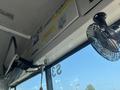 Interior view of a 2007 Blue Bird Vision bus showing signs and a fan mounted to the ceiling along with a window and seat number visible