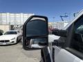 Side mirror of a 2019 Ford F-550 truck showing its black frame and glass reflecting surrounding vehicles