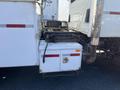 A 2007 International 7300 truck featuring a white utility box mounted on the rear with a latch and wiring visible on the side