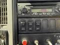 Control panel of a 2009 International 7500 featuring buttons for exhaust brake, locking mechanisms, and various other controls