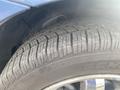 Close-up of a tire from a 2007 Chrysler PT Cruiser showing tread patterns and markings on the sidewall