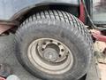 Close-up of a tire from a 2012 Toro Groundsmaster 5910 featuring a rugged tread pattern and visible markings on the tire sidewall
