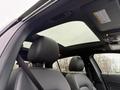 Interior view of a 2016 Mercedes-Benz GLA-250 showing the front seat with a black leather headrest and a panoramic sunroof above