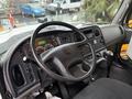 The interior of a 2016 Freightliner 108SD featuring a steering wheel dashboard controls and gear shifter