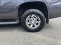 A silver 2016 Chevrolet Tahoe showcasing a chrome wheel with a rugged tire tread