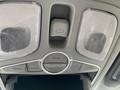Interior overhead console of a 2015 Kia Sorento featuring light buttons and an automatic liftgate control