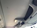 The ceiling of a 2013 International 4300 featuring light fixtures and a mesh storage net